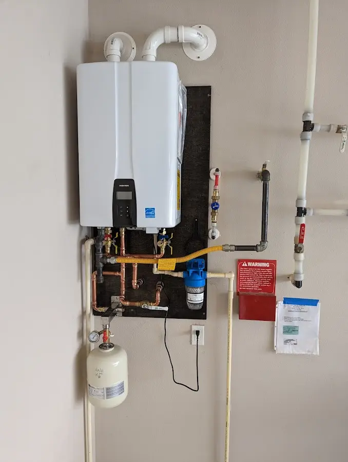 Professional plumber installing copper piping in a Manorhaven home